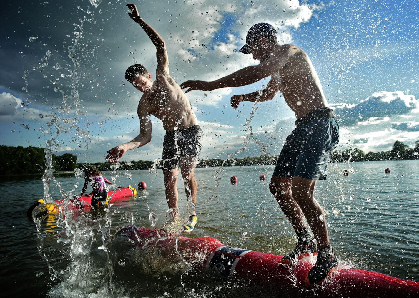 Matt Delaney, left, went against his girlfriend's brother,Will Hoeschler. Both are serious athletes who enjoy the fact that splashing your opponent with water is within the rules of competition. [The Minnesota Log Rolling Club had free tryouts for people interested in trying log rolling at East Cedar Lake Beach. Richard Tsong-Taatarii/rtsong-taatarii@startribune.com