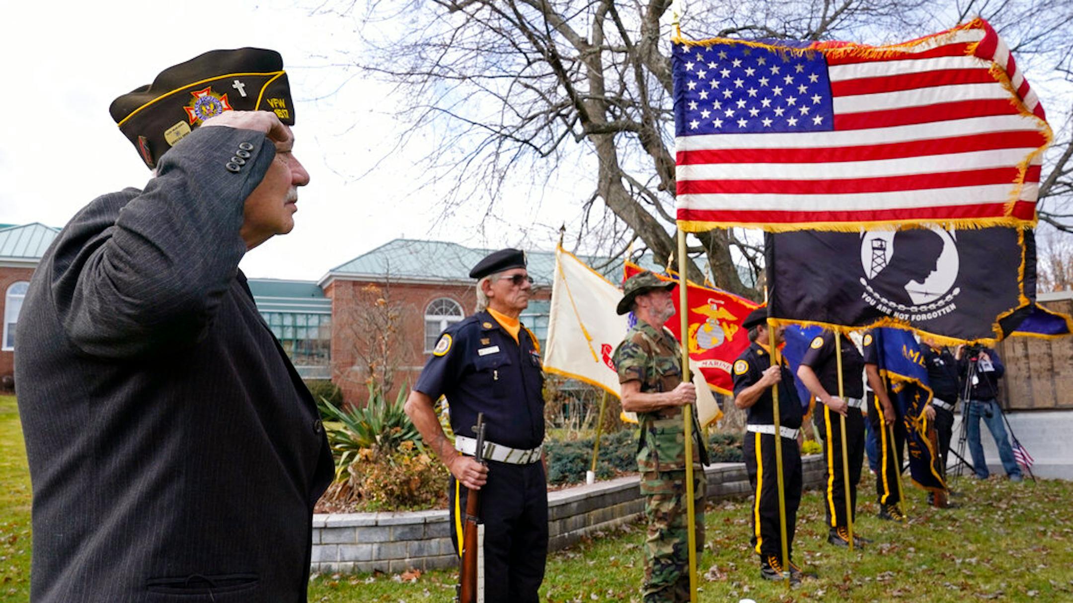 Chaplain Charles Andriolo, of VFW Post 1617, salutes during a Veterans Day ceremony, Wednesday, Nov. 11, 2020, in Derry, N.H. (AP Photo/Charles Krupa)