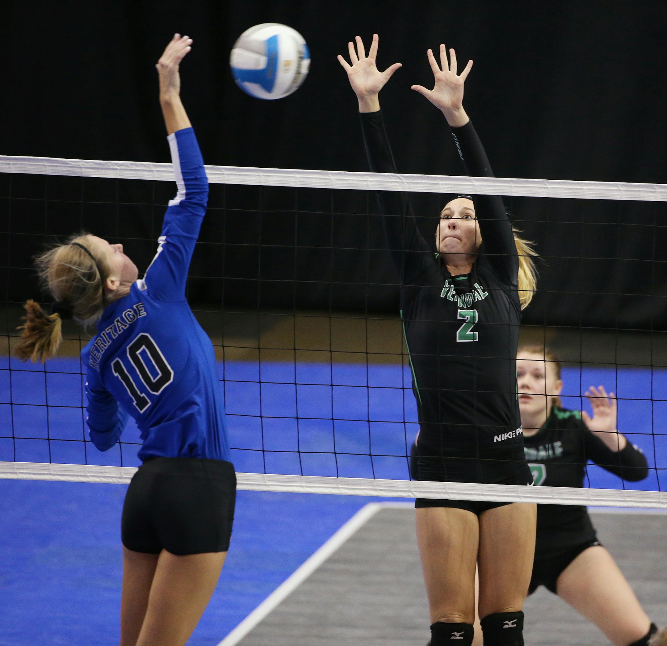 Jenay Fuglestad of Heritage Christian Academy hits the ball past the block of Allison Olsson of Verndale. ] (Leila Navidi/Star Tribune) leila.navidi@startribune.com Heritage Christian Academy, Maple Grove and Verndale play in the Class A girls volleyball state quarterfinals at the Xcel Energy Center in St. Paul on Thursday, November 12, 2015.