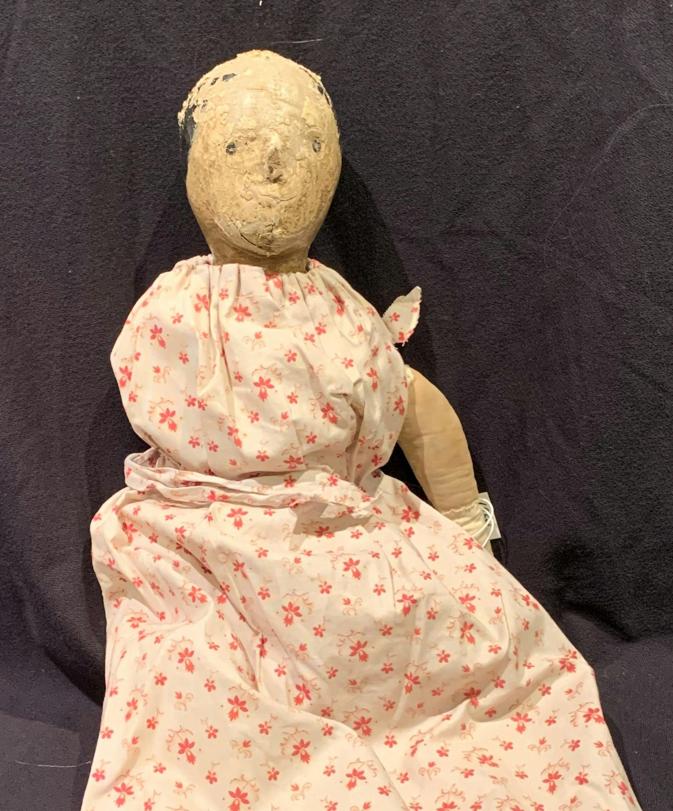 This doll once may have been beautiful, but age and use have mummified it.