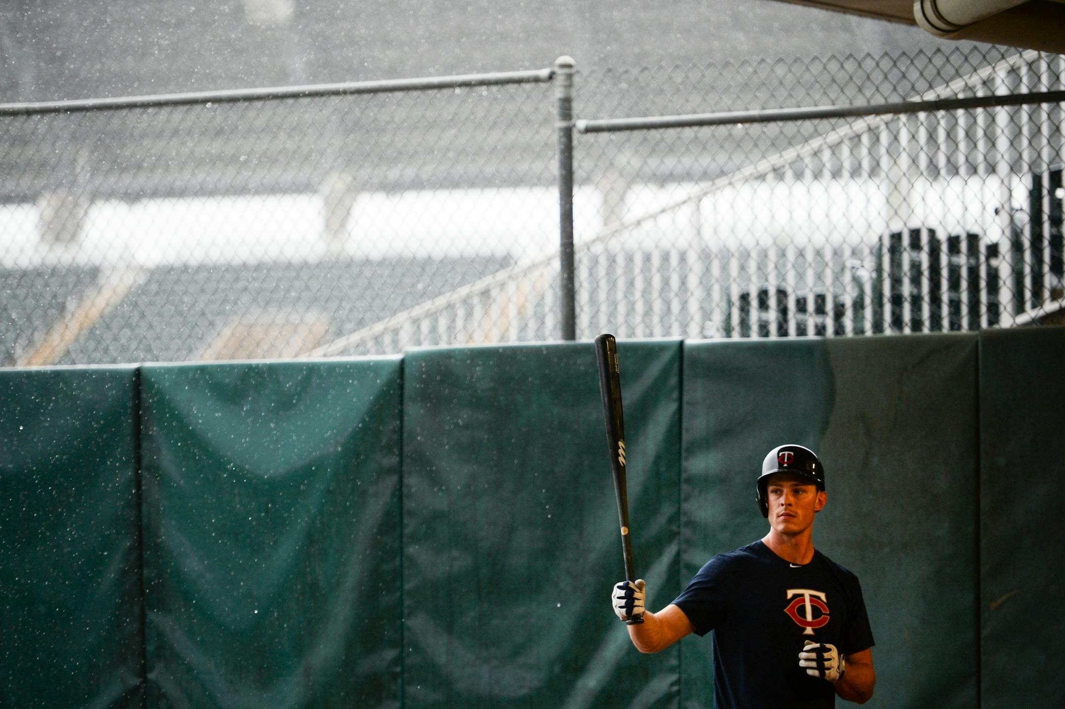 Minnesota Twins outfielder Max Kepler (26) reset his batting stance while tracking pitches in the bullpen Wednesday. Rain moved practice into the batting cages and the covered portion of the bullpen.