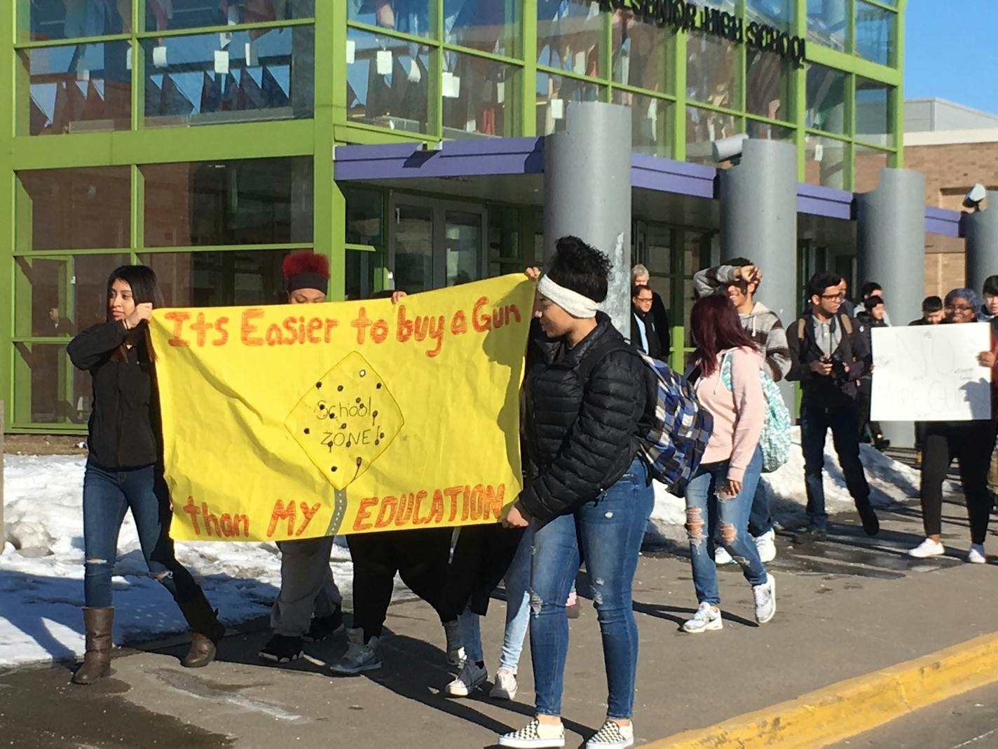 Students pour out of Harding High School in St.Paul in one of the largest Minnesota school events joining the #ENOUGH National School Walkout.