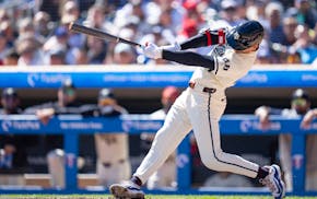 Minnesota Twins second base Edouard Julien (47) hits a home run on Los Angeles Dodgers starting pitcher Bobby Miller (28) in the second inning at Targ