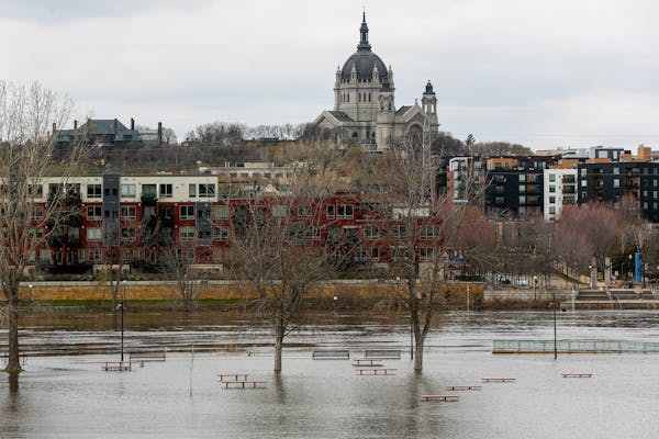 Benches and tables at Harriet Island Regional Park sit partially submerged in water Sunday, April 23, 2023, during a period of high spring flooding in