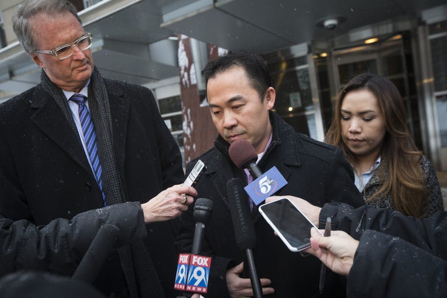 Koua Fong Lee stood with his wife Panghoua Moua, right, and attorney Bob Hilliard, left, after a verdict in the Toyota liability trial that found the automaker 60 percent responsible and Lee 40 percent responsible for a 2006 crash that caused the deaths of three people and sent a St. Paul man to prison for more than two years, outside the Federal Courthouse in downtown Minneapolis, Minn. on Tuesday, February 3, 2015.