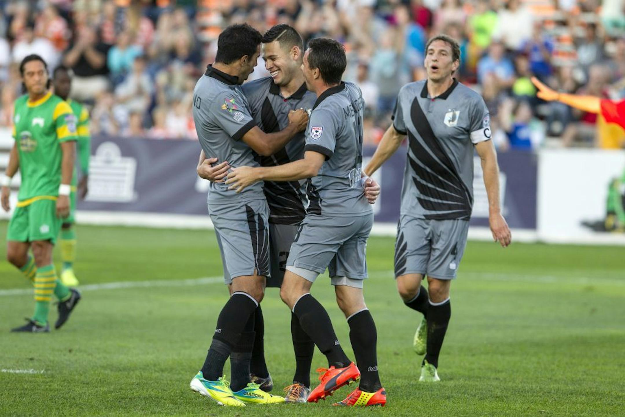 United's Christian Ramirez, center, celebrates with teammates after scoring with a penalty kick in the first half of Minnesota United FC's game against the Tampa Bay Rowdies at the National Sports Center Stadium in Blaine September 6, 2014. Ramirez was just named North American Soccer League Player of the Month.