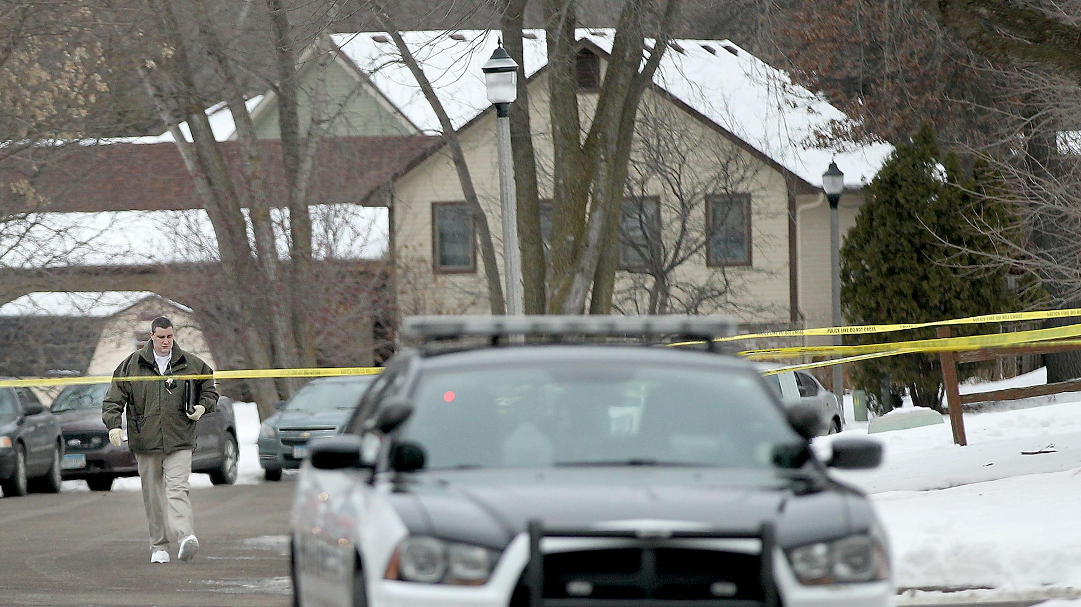 Police comb the scene in an Oakdale neighborhood where several shots were fired and a police officer was shot in the arm Thursday.
