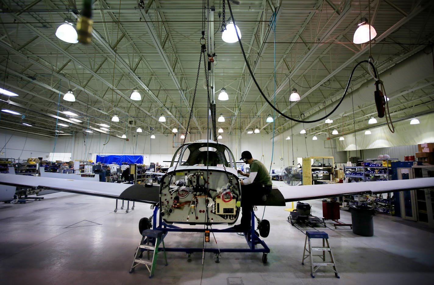 With a fresh cash infusion from its Chinese owner and a new jet launch on the horizon, Duluth-based Cirrus Aircraft is hiring again after slashing more than half its workforce during the recession. Here, assembly of propeller aircraft will have to make way for the new Vision SF50 jet that will go into production in 2015.