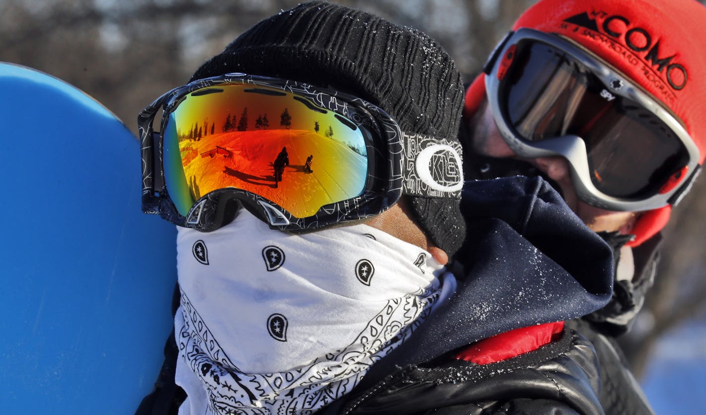 While some Minnesotans head south to warmer climes, others embrace January sub-zero temperatures by heading to recreation sites at area parks. Franco Zerna, St. Paul, left and Scott Franta, Roseville, bundled-up against the cold as they rode a rope tow at St. Paul's Como Park sliding and ski hill.