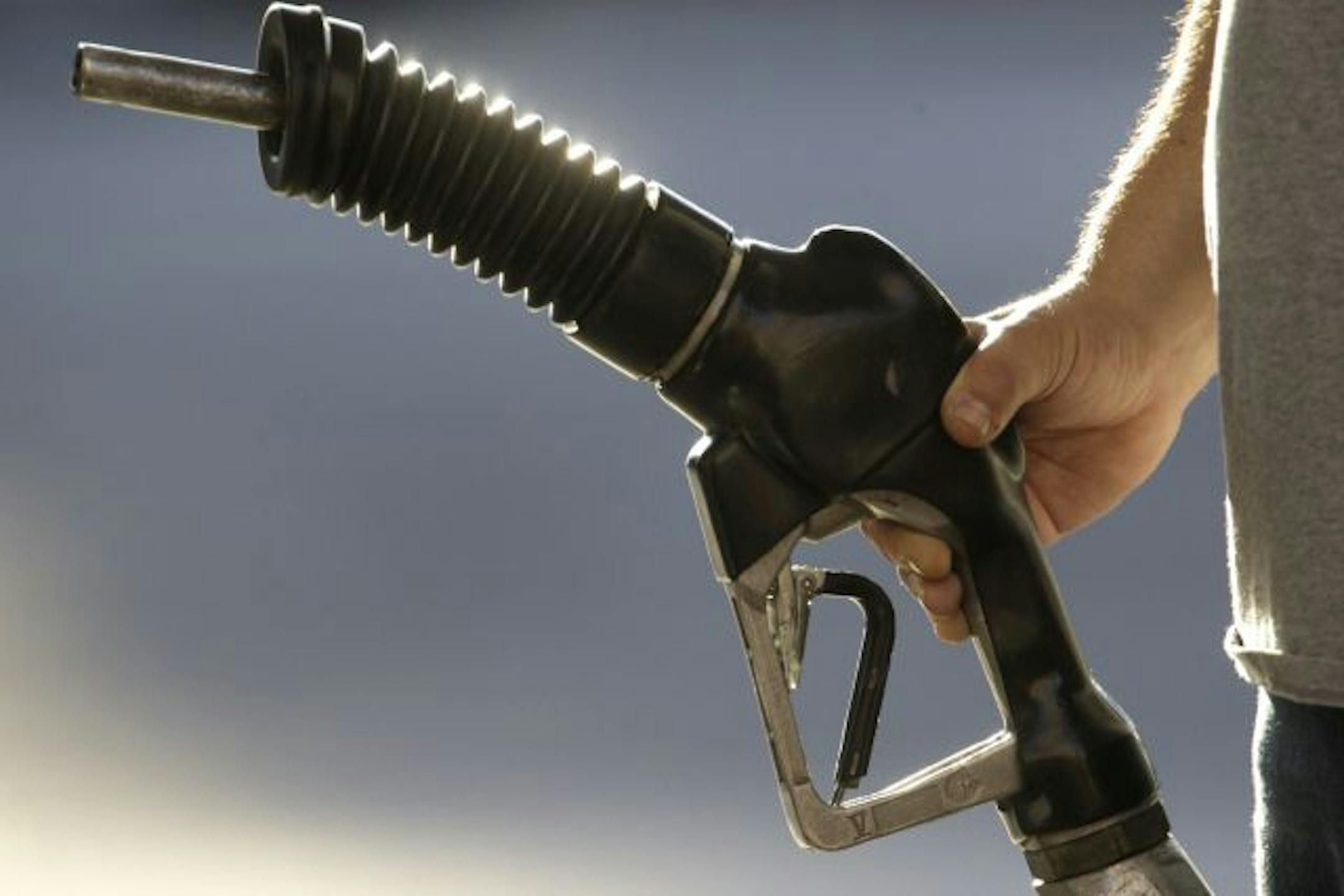 FILE - In this July 21, 2009 file photo, a gas station attendant pumps gas in Portland, Ore. Crude and gasoline prices on Wednesday, Sept. 23, 2009 fell sharply on more evidence of a huge glut in supply, with the economy still damaged by the worst recession since the 1930s.