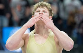 Waconia wrestler Max McEnelly celebrates after defeating Stillwater wrestler Ryder Rogotzke in the Class 3A 195lb weight class to win his fourth state