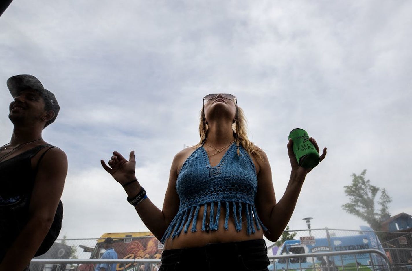 Alyssa Eisen, 23, of Osceola, Wis., cooled off under a mister at Soundset at the Minnesota State Fair grounds on Sunday.