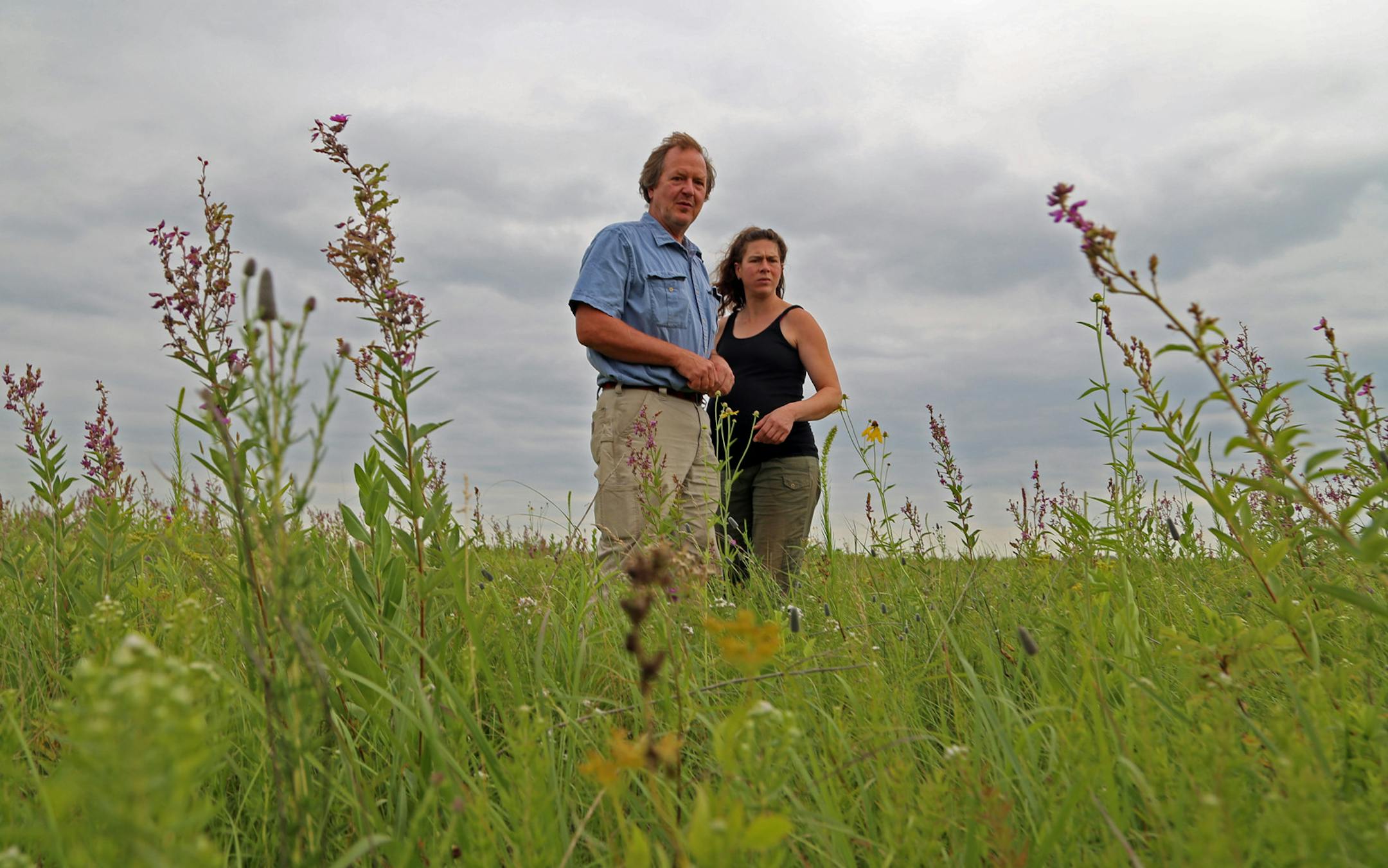 Tony Thompson and his wife Sonya Buller in a field of virgin prairie they cultivate for wildflower and other seeds. The seeds are sold to state and federal conservation agencies, and conservation groups such as The Nature Conservancy.