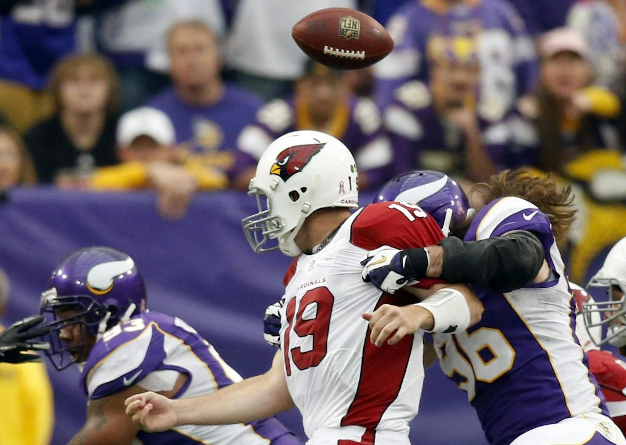 Brian Robison (96) forced Cardinals quarterback John Skelton (19) to fumble in the first quarter. Kevin Williams (93) recovered the ball on the play.
