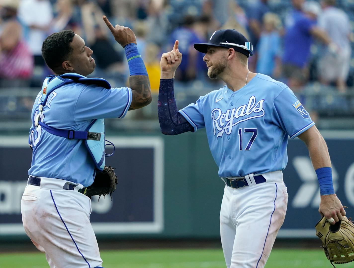 Kansas City Royals catcher Salvador Perez, left, and third baseman Hunter Dozier celebrate their win over the Minnesota Twins in a baseball game Saturday July 3, 2021, in Kansas City, Mo. (AP Photo/Ed Zurga)