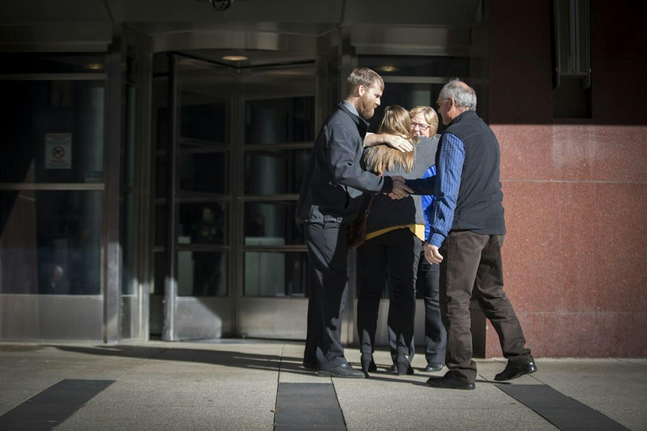 People hugged outside the U.S. Courthouse on Monday morning shortly after the sentencing for Danny Heinrich on November 21, 2016, in Minneapolis, Minn.