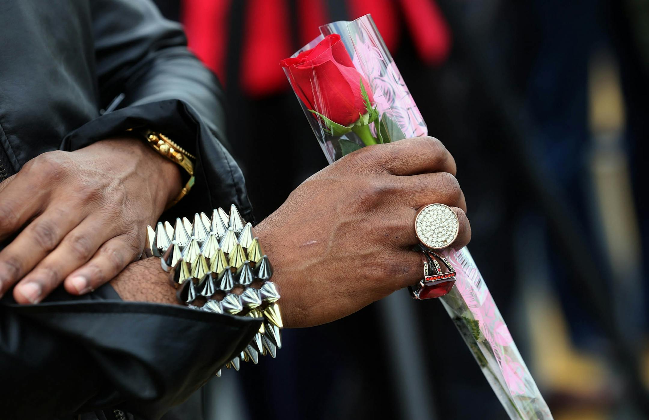 A mourner prepared to place a rose at the memorial.