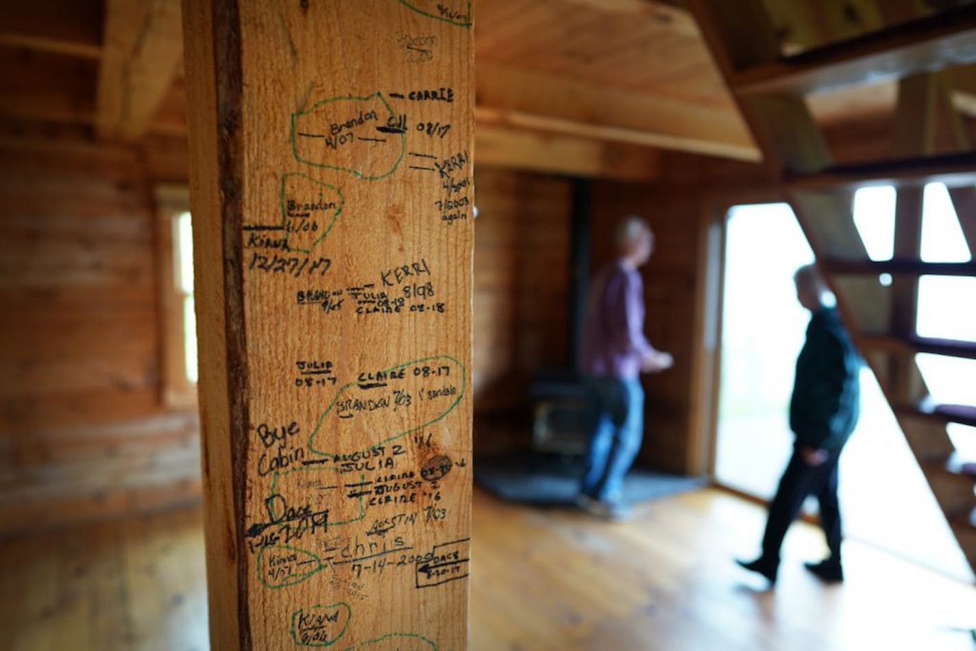 20 years of memories are etched in a beam in the Briggs cabin. Mike and Kathy Briggs, of Cannon Falls, bought a little log cabin on the south shore of Lake Superior 21 years ago as their dream property. But in the past four years or so, the property has been shrinking. The edge of the clay cliff in front of their structure has been creeping closer, about 20 feet a year as Lake Superior eats away at it. It's now about 10 feet away from their deck.