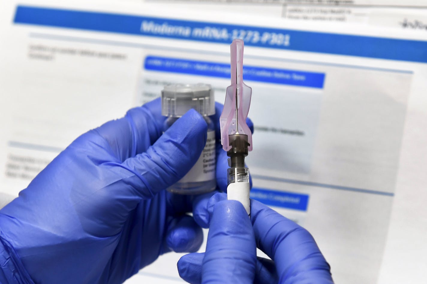 A nurse prepares a shot as a study of a possible COVID-19 vaccine, developed by the National Institutes of Health and Moderna Inc., gets underway in New York on July 27.