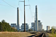File- This Oct. 20, 2010, file photo shows Xcel Energy's Sherco Power Plant in Becker, Minn. Minnesota, which already successfully lowered carbon emis