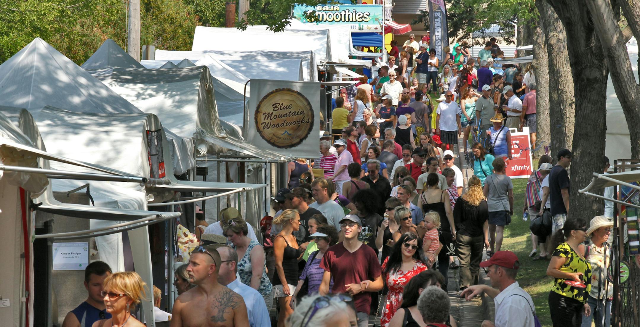 The Uptown Art Fair convenes again this weekend at the intersection of Hennepin Ave. and Lake Street. Crowds made their way along the booths. (MARLIN LEVISON/STARTRIBUNE(mlevison@startribune.com (cq )