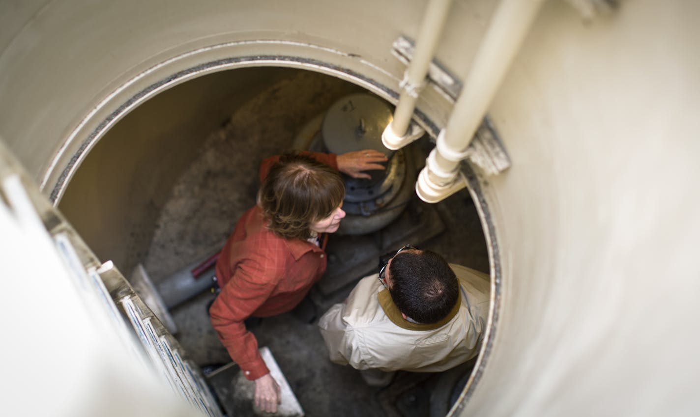 Lt. Gov. Tina Smith and Dennison Mayor Jeffrey Flaten chatted inside a lift station Flaten checks daily to make sure the town's human waste does not back up and contaminate the watersheds on Tuesday, March 29, 2016, in Dennison, Minn. ] RENEE JONES SCHNEIDER &#x2022; reneejones@startribune.com Lt. Gov. Tina Smith saw firsthand the aging wastewater infrastructure of the small city of Dennison, where Mayor Jeffrey Flaten heads down into the lift station to clear away debris so human waste can flow