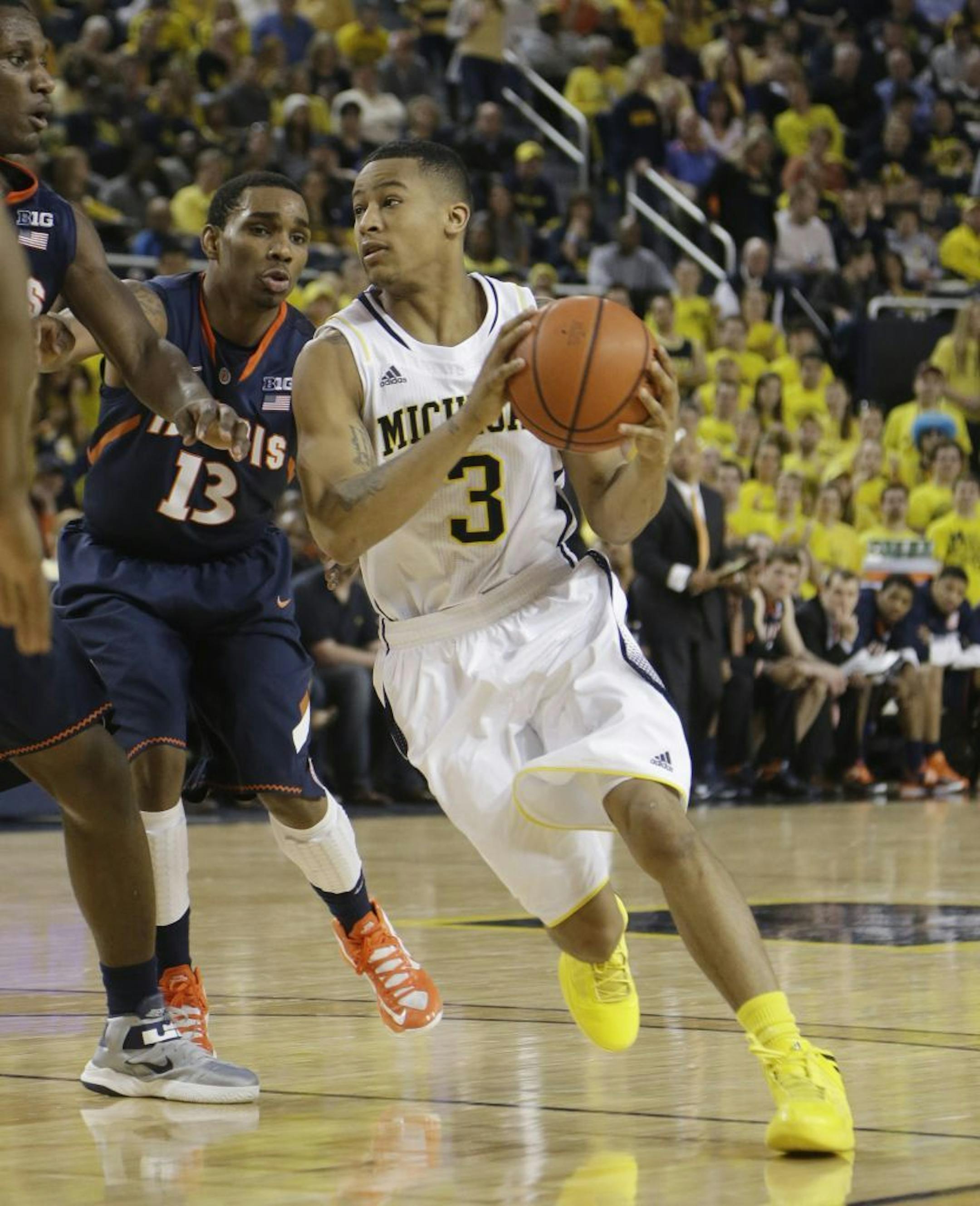 Michigan guard Trey Burke (3) drives on Illinois guard Tracy Abrams (13) during the second half of an NCAA college basketball game, Sunday, Feb. 24, 2013 in Ann Arbor, Mich.