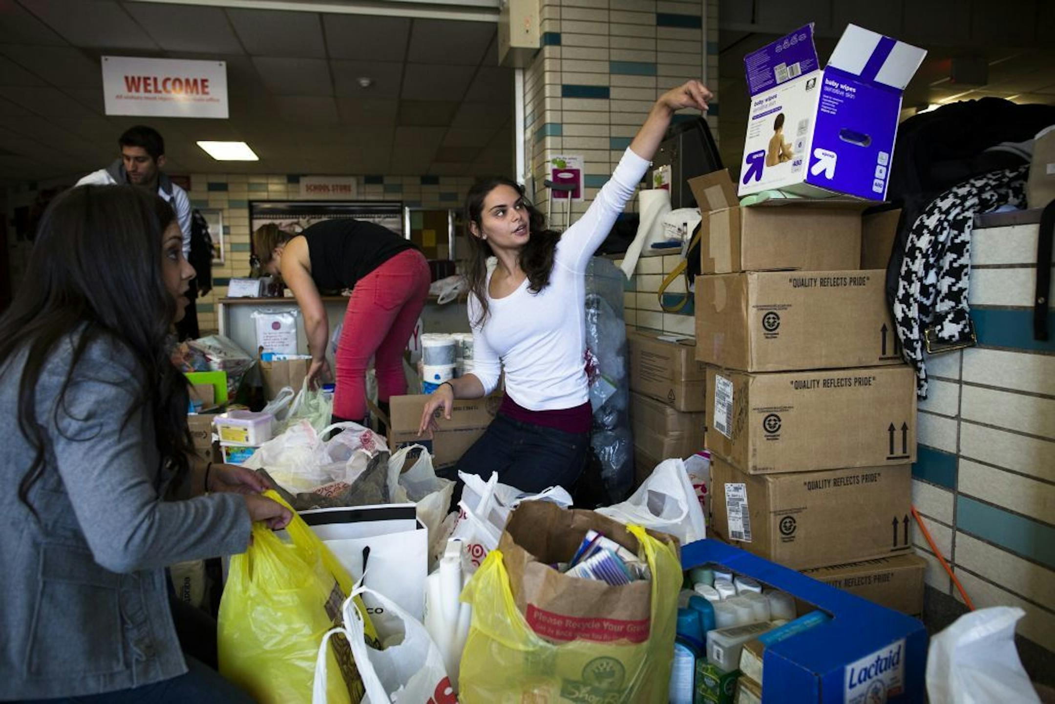 A volunteer helps sort through donations at Hoboken High School in New Jersey.