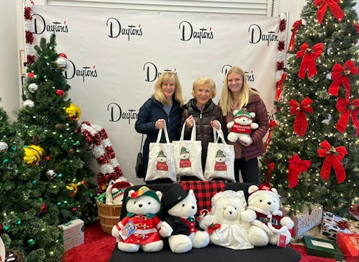 Shoppers pose with their 2023 Santa Bear purchases at the Dayton's Project holiday market on Nicollet Mall.