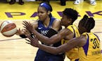 Maya Moore, left, fights for the loose ball against the Los Angeles Sparks' Alana Beard, middle, Nneka Ogwumike during the game that eliminated the Ly