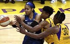 Maya Moore, left, fights for the loose ball against the Los Angeles Sparks' Alana Beard, middle, Nneka Ogwumike during the game that eliminated the Ly