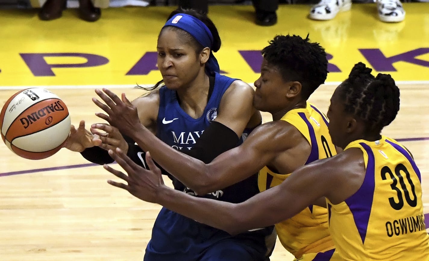 Maya Moore, left, fights for the loose ball against the Los Angeles Sparks' Alana Beard, middle, Nneka Ogwumike during the game that eliminated the Lynx from the 2018 playoffs.