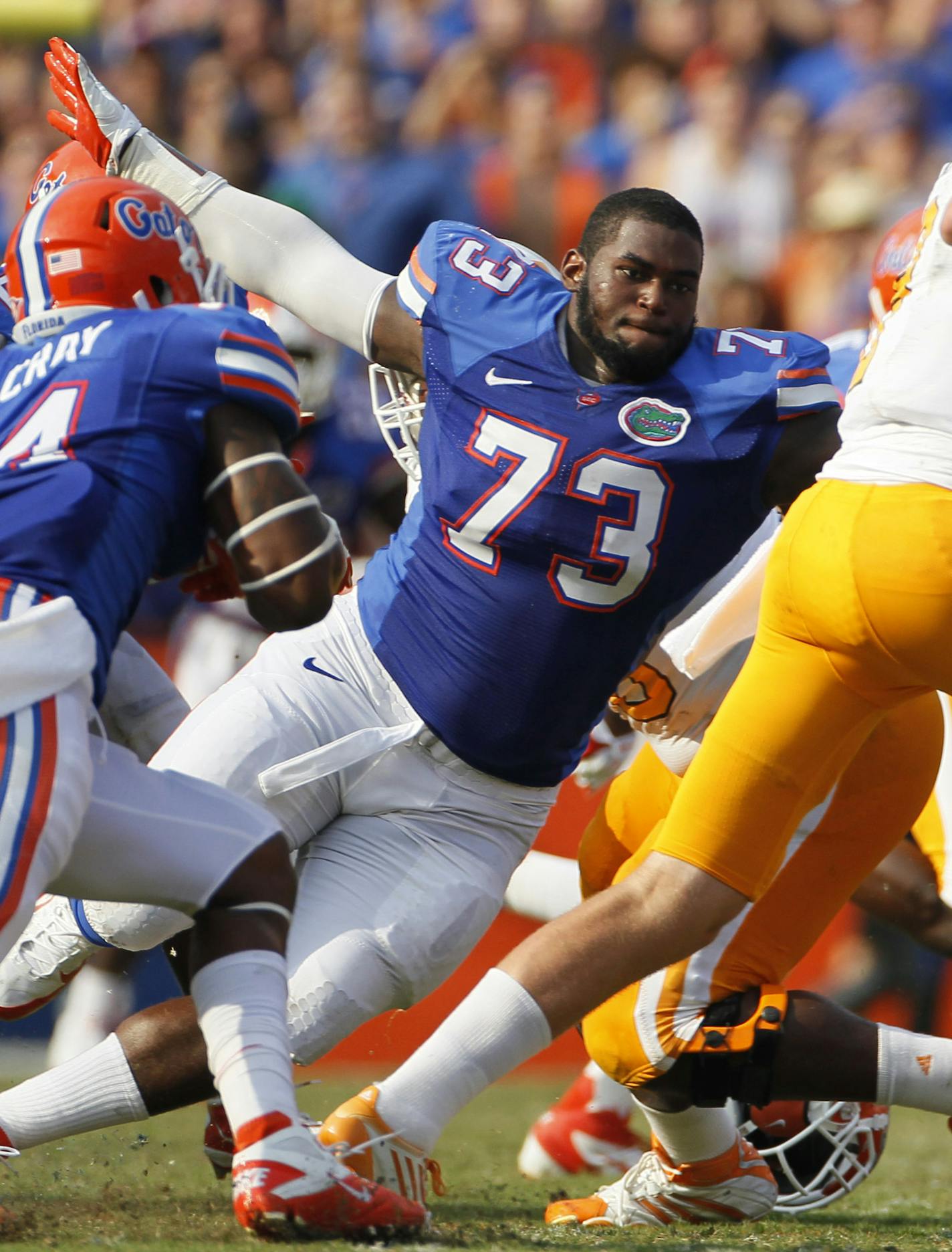 BRUCE MOYER / TIMES SP_344140_MOYE_GATORS_04 CAPTION: (9/17/11)(Gainesville, FL) Florida Gators defensive tackle Sharrif Floyd (73) chases tennessee quarterback Tennessee Volunteers quarterback Tyler Bray (8) despite loosing his helmet during the Florida Gators vs. Tennessee Volunteers football game at Ben Hill Griffin Stadium on Saturday, September 17, 2011. (Bruce Moyer, TIMES) Florida Gators quarterback John Brantley (12) ORG XMIT: 344140