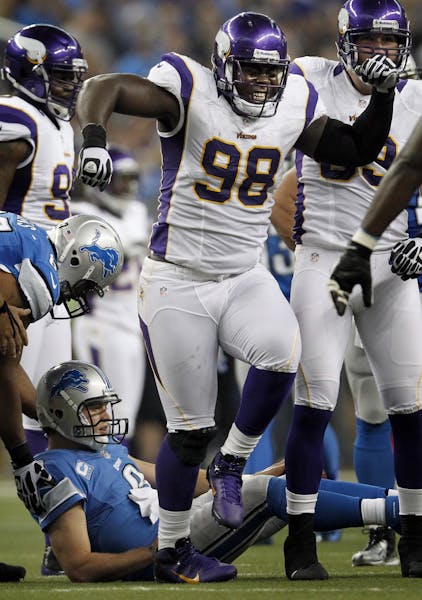 Letroy Guion (98) celebrated after sacking Lions quarterback Matthew Stafford (9).