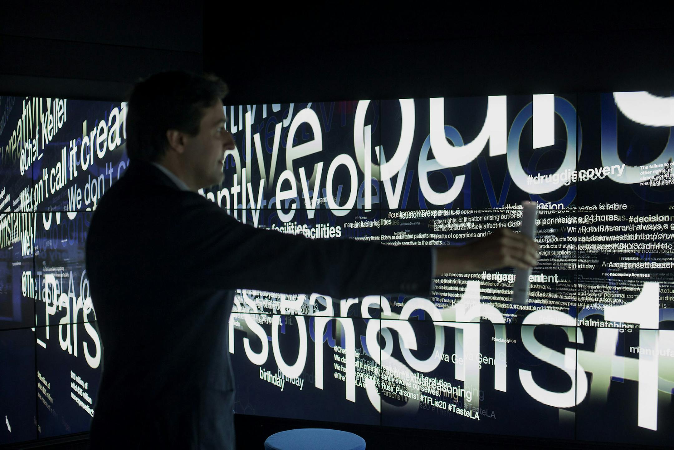 Dario Gil, director of symbiotic cognitive systems at IBM Research, holds a remote control wand while giving a demonstration of the International Business Machines Corp. (IBM) Watson immersion room during an event at the company's headquarters in New York, U.S., on Tuesday, Oct. 7, 2014. To help commercialize the technology famous for beating humans on the "Jeopardy!" game show, new languages such as Portuguese and Japanese are being added to the Watson service this year, said Stephen Gold, vice