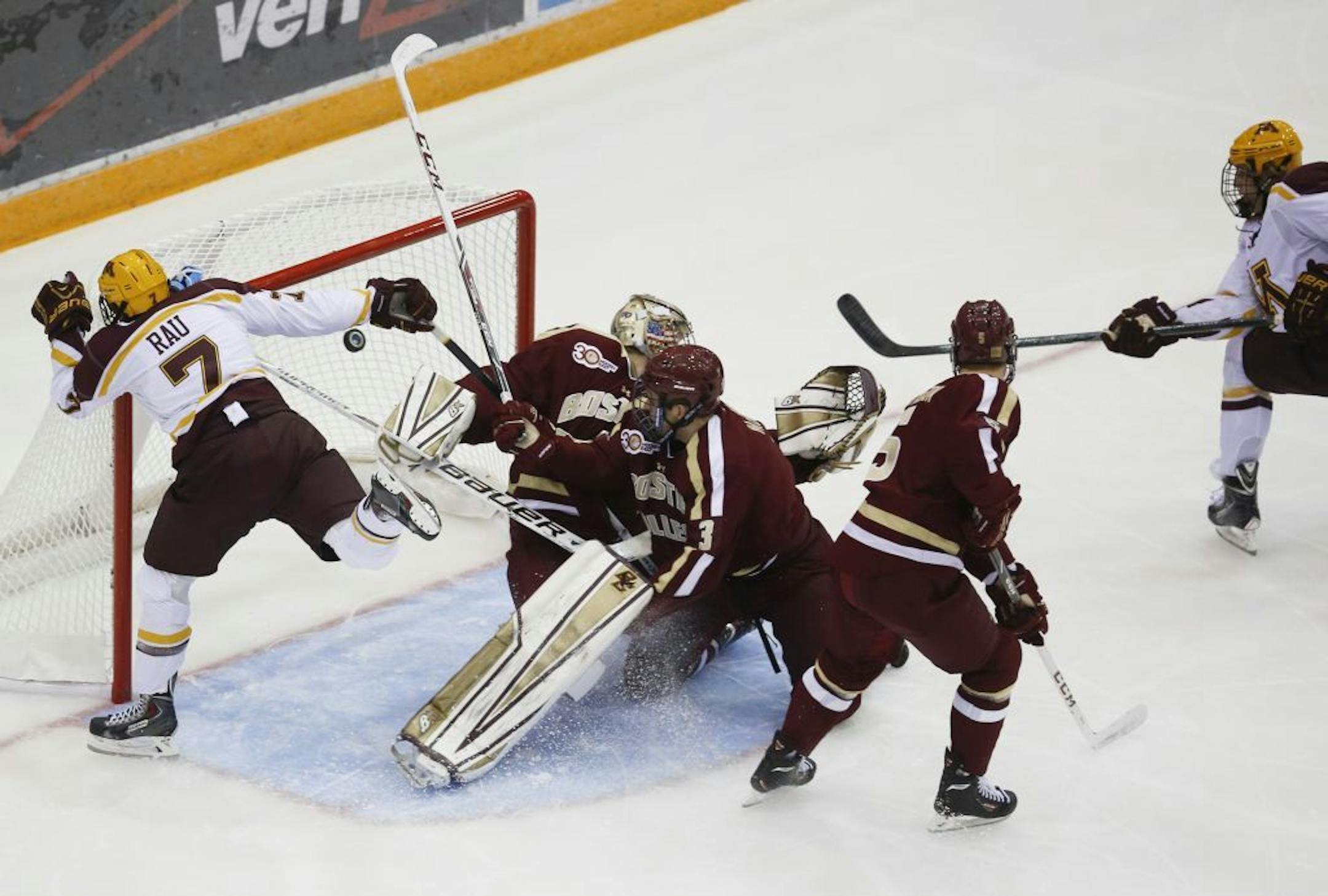 Hudson Fasching (24), right, scored the game's first goal in the first period, past Boston College goalie Thatcher Demko.