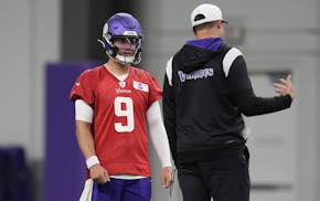 Vikings quarterback J.J. McCarthy (9) and head coach Kevin O'Connell talk during organized team activities Wednesday at TCO Performance Center.