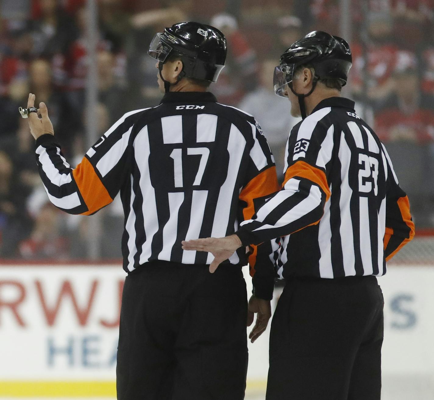 Columbus Blue Jackets left wing Nick Foligno (71) talks to officials Frederick L'Ecuyer (17) and Brad Watson (23) during the second period of an NHL hockey game, Sunday, March 5, 2017, in Newark, N.J. (AP Photo/Julio Cortez) ORG XMIT: NJJC10