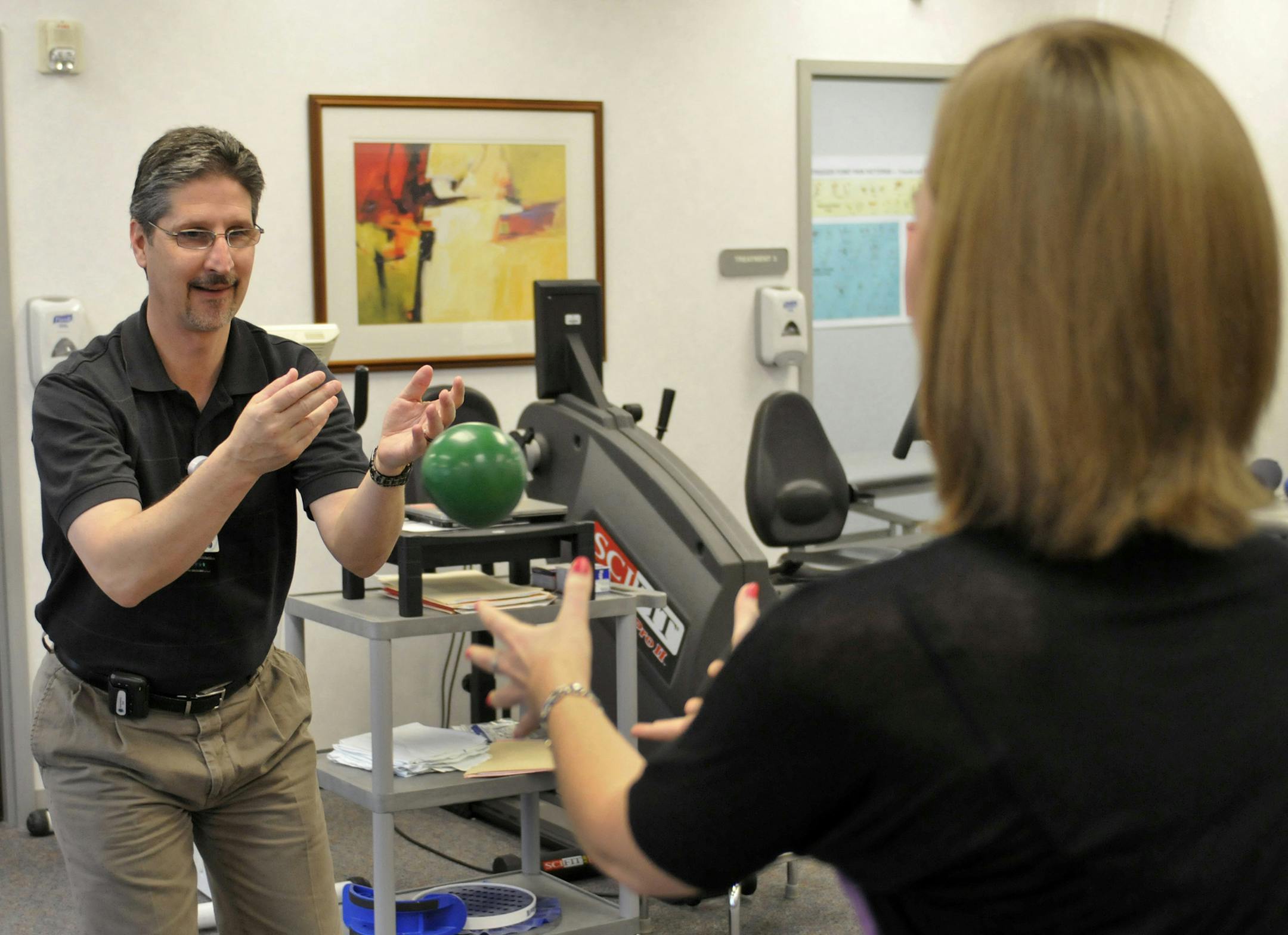 Dr. David Aiken works with Haley Pillars on her physical therapy in Charlotte, North Carolina, on April 15, 2013. (Davie Hinshaw/Charlotte Observer/MCT) ORG XMIT: 1138305