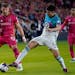 St. Louis City's Eduard Lowen (10) and Minnesota United's Miguel Tapias (4) battle for the ball during the second half of an MLS soccer match Saturday