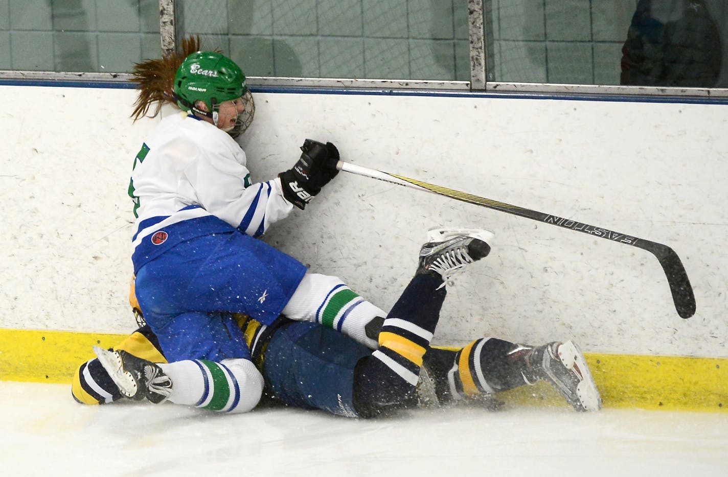 Blake defenseman Madeline Wethington (5) and Breck forward Grace Zumwinkle (4) collided against the boards during the first period Thursday.