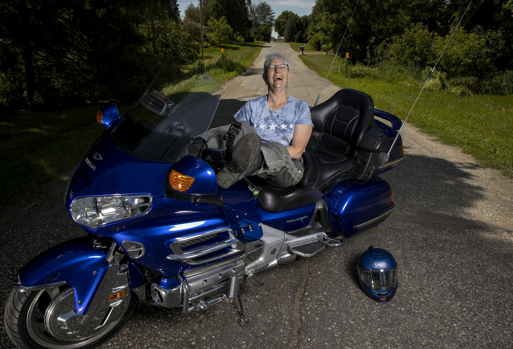 Carol Hauck photographed with her Honda Goldwing motorcycle. ] CARLOS GONZALEZ • cgonzalez@startribune.com – Chaska, MN – August 4, 2020, Carol Hauck is marking the centennial celebration of U.S. women's right to vote in the most badass way possible -- with an all-women commemorative motorcycle ride across several states.