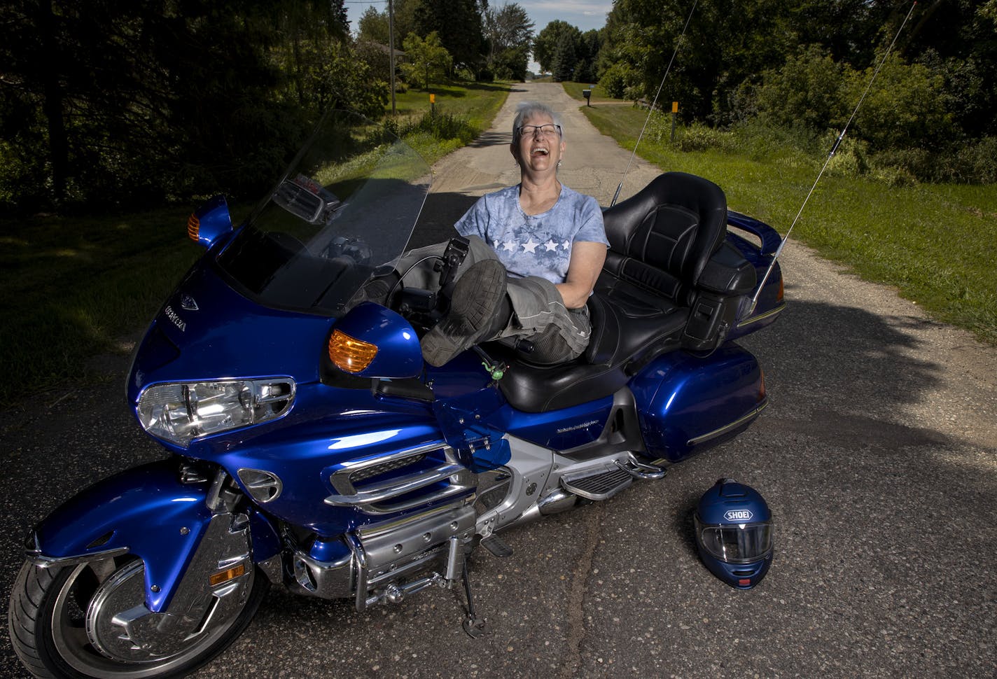 Carol Hauck photographed with her Honda Goldwing motorcycle. ] CARLOS GONZALEZ • cgonzalez@startribune.com – Chaska, MN – August 4, 2020, Carol Hauck is marking the centennial celebration of U.S. women's right to vote in the most badass way possible -- with an all-women commemorative motorcycle ride across several states.