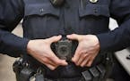 In this Feb. 16, 2017 photo, Maplewood Police Officer Parker Olding attaches his body camera to the magnetic plate worn inside his uniform in Maplewoo