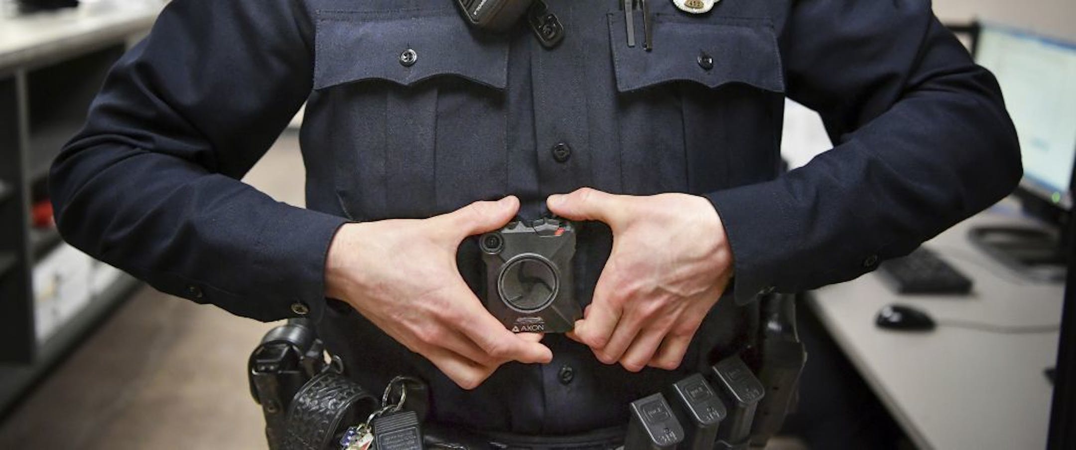 In this Feb. 16, 2017 photo, Maplewood Police Officer Parker Olding attaches his body camera to the magnetic plate worn inside his uniform in Maplewood, Minn. When a Minneapolis police officer shot and killed Justine Damond, who had called in a possible crime in the alley behind her house on July 15, his body camera wasn't running. Criminal-justice experts say the early numbers suggest that officers aren't turning them on often enough, and Minneapolis isn't the only city where that's the case.
