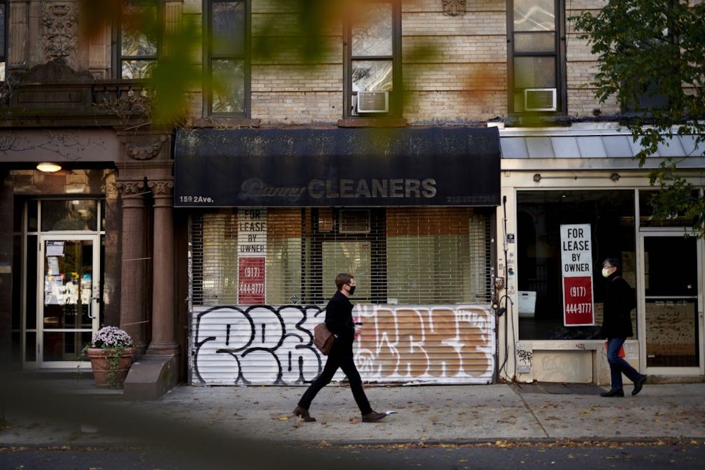 Pedestrians pass in front of Danny Cleaners in the New York borough of Manhattan on Nov. 19, 2020. MUST CREDIT: Bloomberg photo by Gabby Jones.