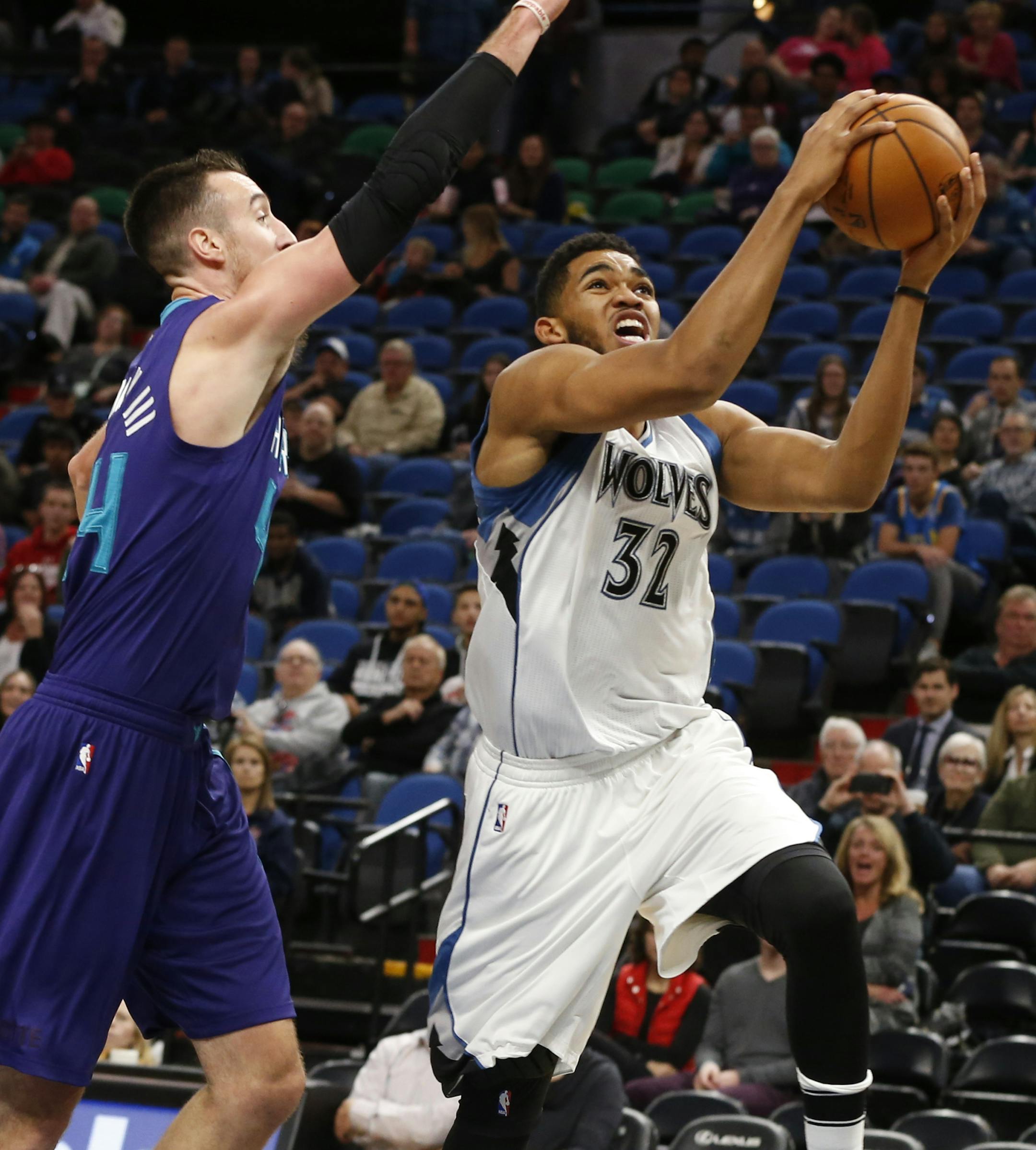 Wolves center Karl-Anthony Towns drove on the Hornets’ Frank Kaminsky on Friday. Towns scored 15 points and grabbed nine rebounds