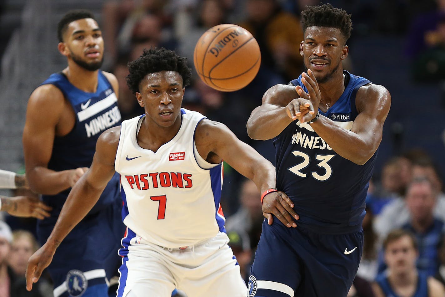 Minnesota Timberwolves forward Jimmy Butler (23) passes the ball against Detroit Pistons forward Stanley Johnson (7) in the second half of an NBA basketball game, Sunday, Nov. 19, 2017, in Minneapolis. Detroit won 100-97. (AP Photo/Stacy Bengs)