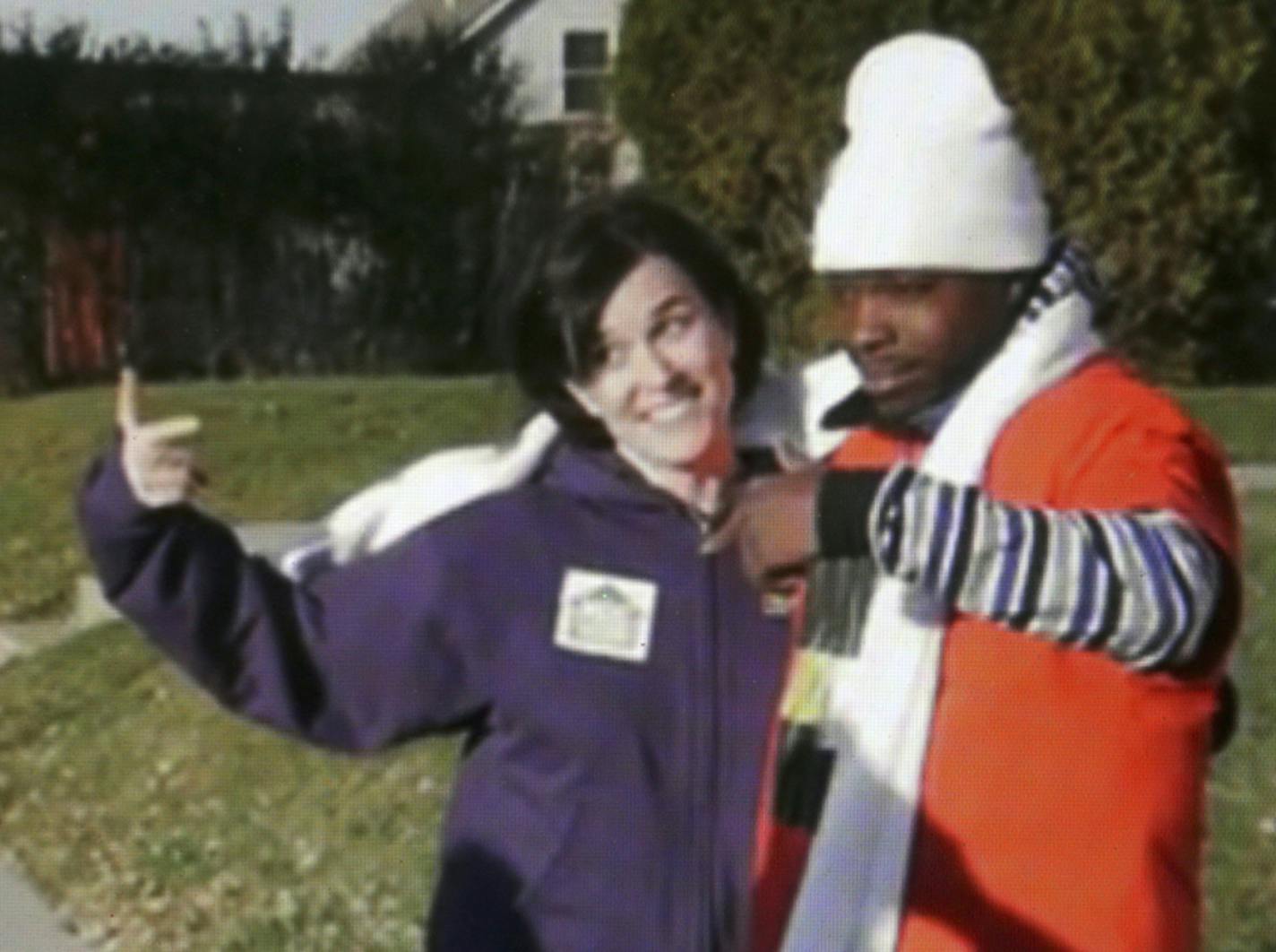 In this image made from a video released by Neighborhoods Organizing for Change, Minneapolis Mayor Betsy Hodges and Neighborhoods Organizing for Change employee Navell Gordon gesture while they knock on doors to get out the vote in north Minneapolis last Saturday, Nov. 1, 2014. A spokeswoman for Mayor Hodges says the mayor and a community activist are pointing at each other, not flashing a gang sign.