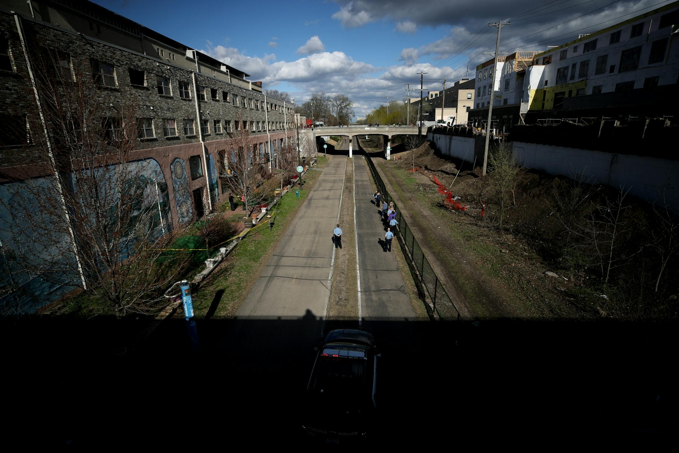 Minneapolis police officers and crime lab investigators look over the scene after two children fell from an apartment building at S. 28th and Pleasant Avenue Thursday May 2, 2019 in Minneapolis, MN.